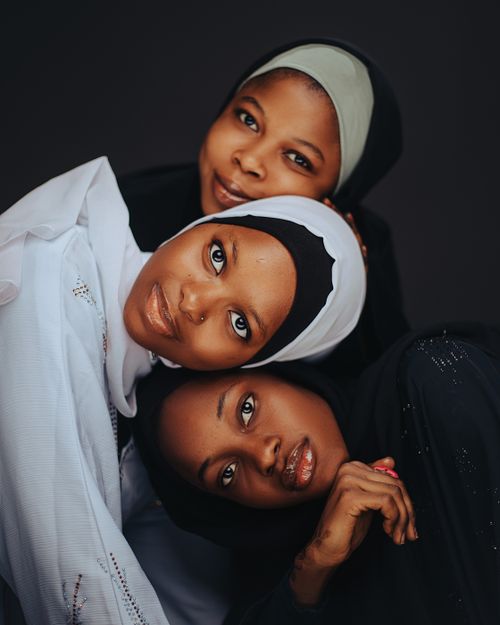 Free Beautiful and serene portrait of three women wearing hijabs, showcasing a sense of unity and grace. Stock Photo