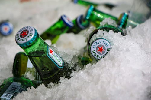 Close-up of Bottles of Beer Lying in Ice 