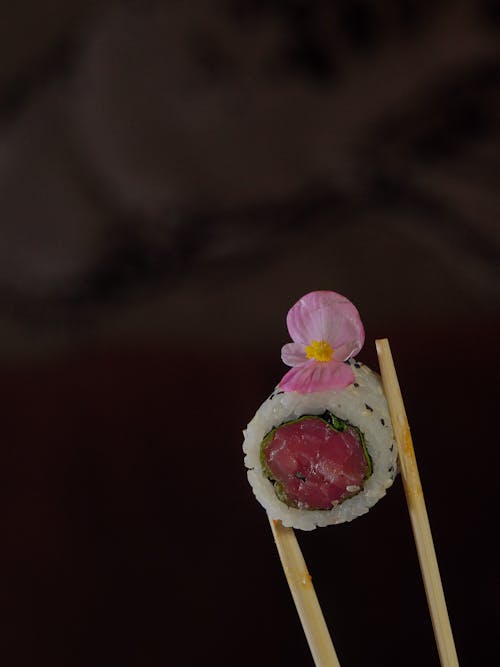 A sushi roll with a flower on top