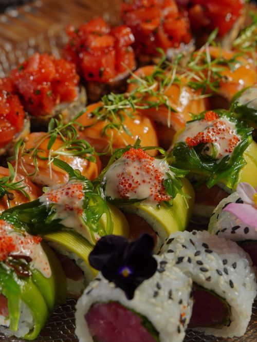 Free An exquisite collection of colorful sushi rolls with toppings, perfect for gourmet dining. Stock Photo