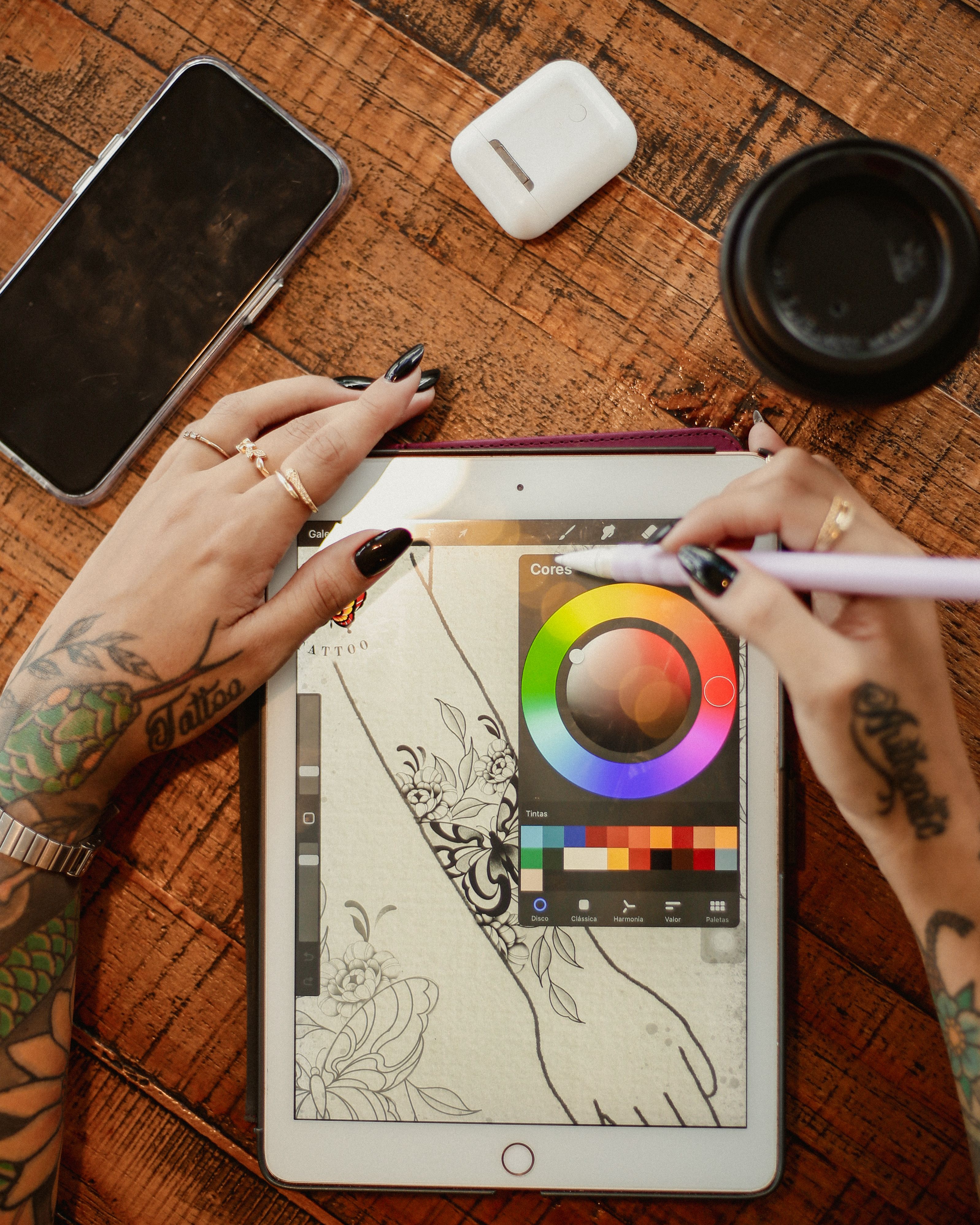 Artist Drawing Tattoos on Tablet · Free Stock Photo