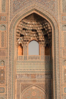 Close-up of a detailed mosaic arch at a mosque, showcasing Islamic architecture's intricate designs.