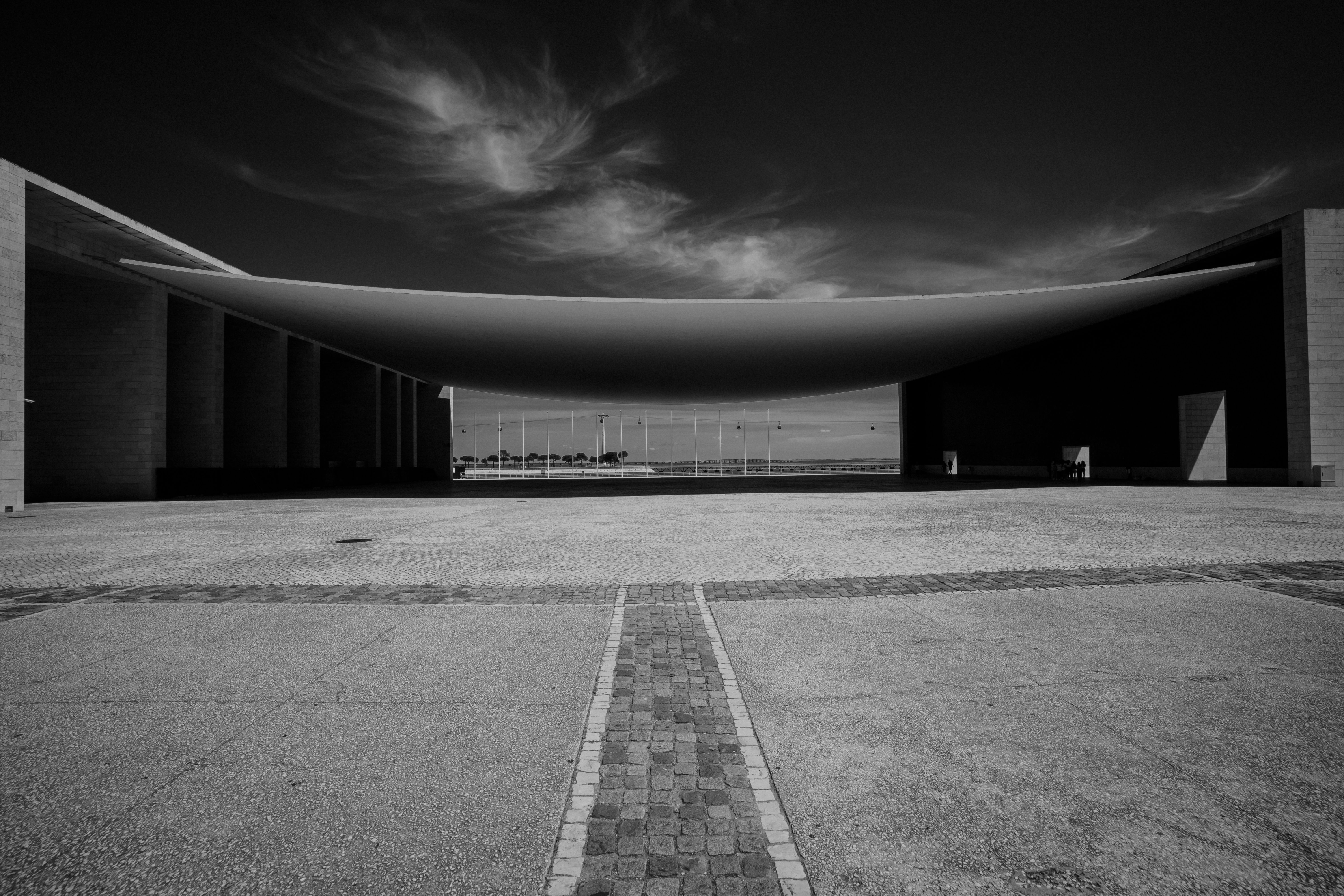 Black and white photo of the Pavilion of Portugal in Lisbon showcasing its modern architecture.