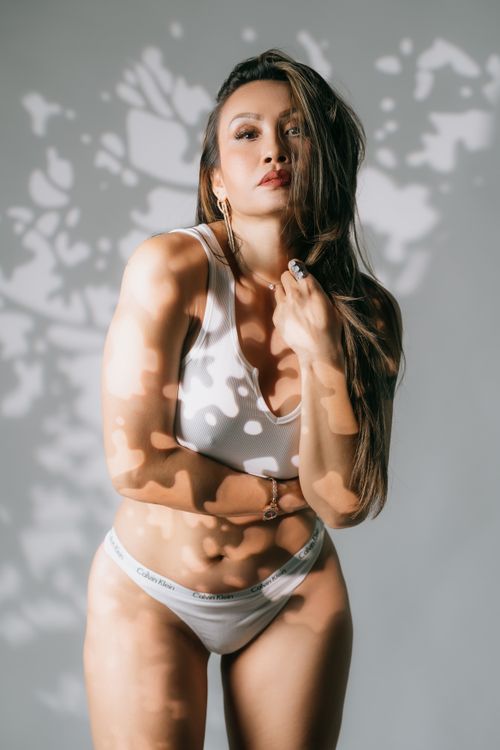 Free Fashion portrait of a woman in underwear with artistic shadows on a white background. Stock Photo
