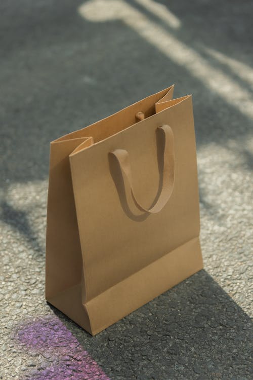 Close-up of a Paper Bag Standing on a Street 