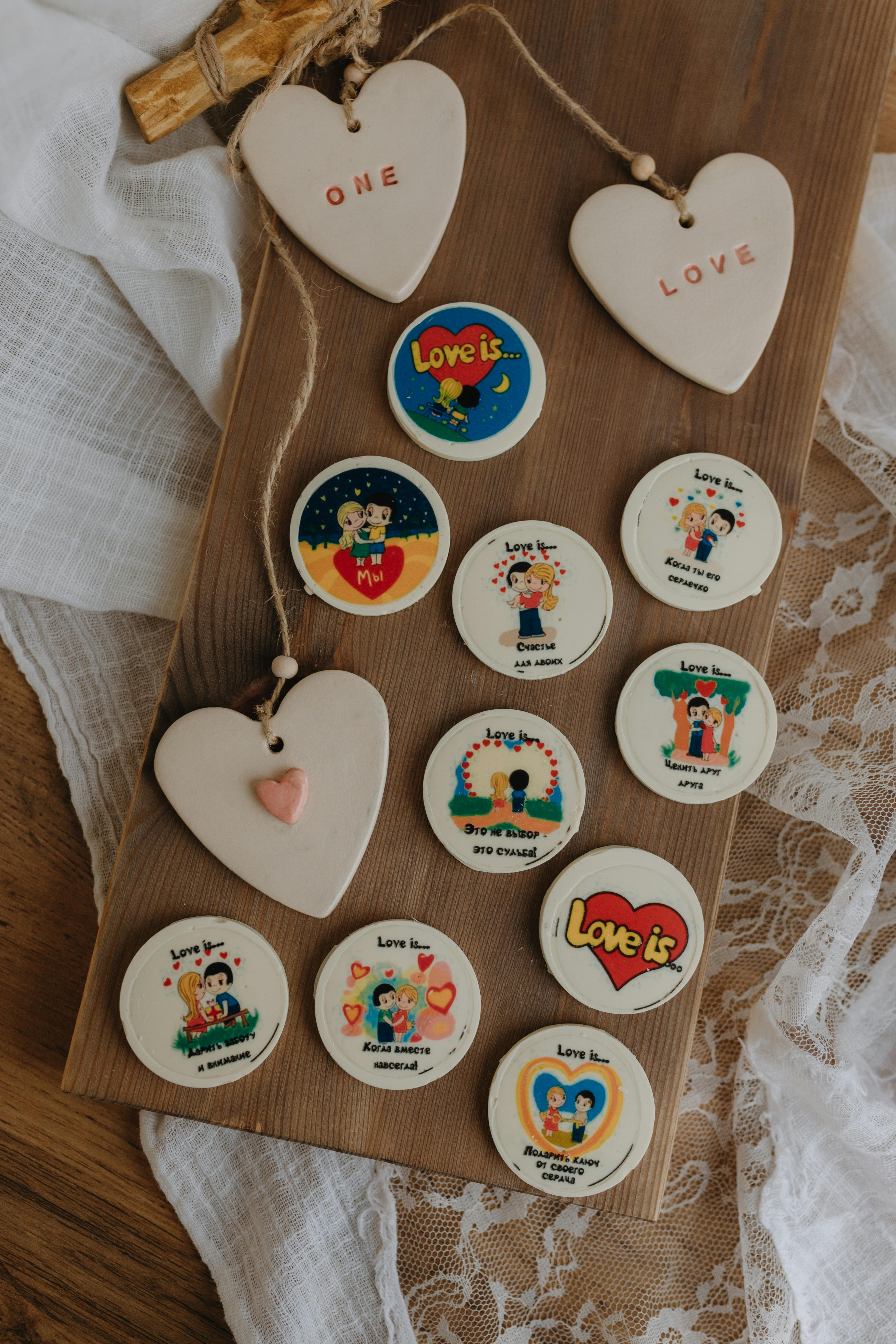 A display of handmade love-themed crafts on a rustic wooden board.