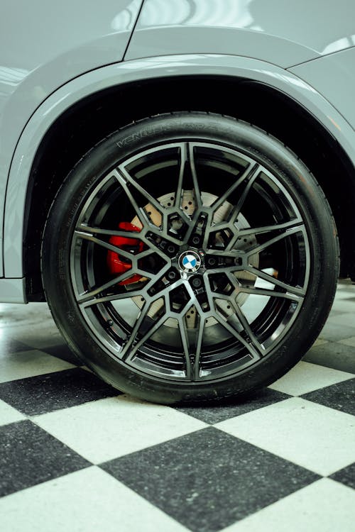 The wheel of a bmw car on a checkered floor
