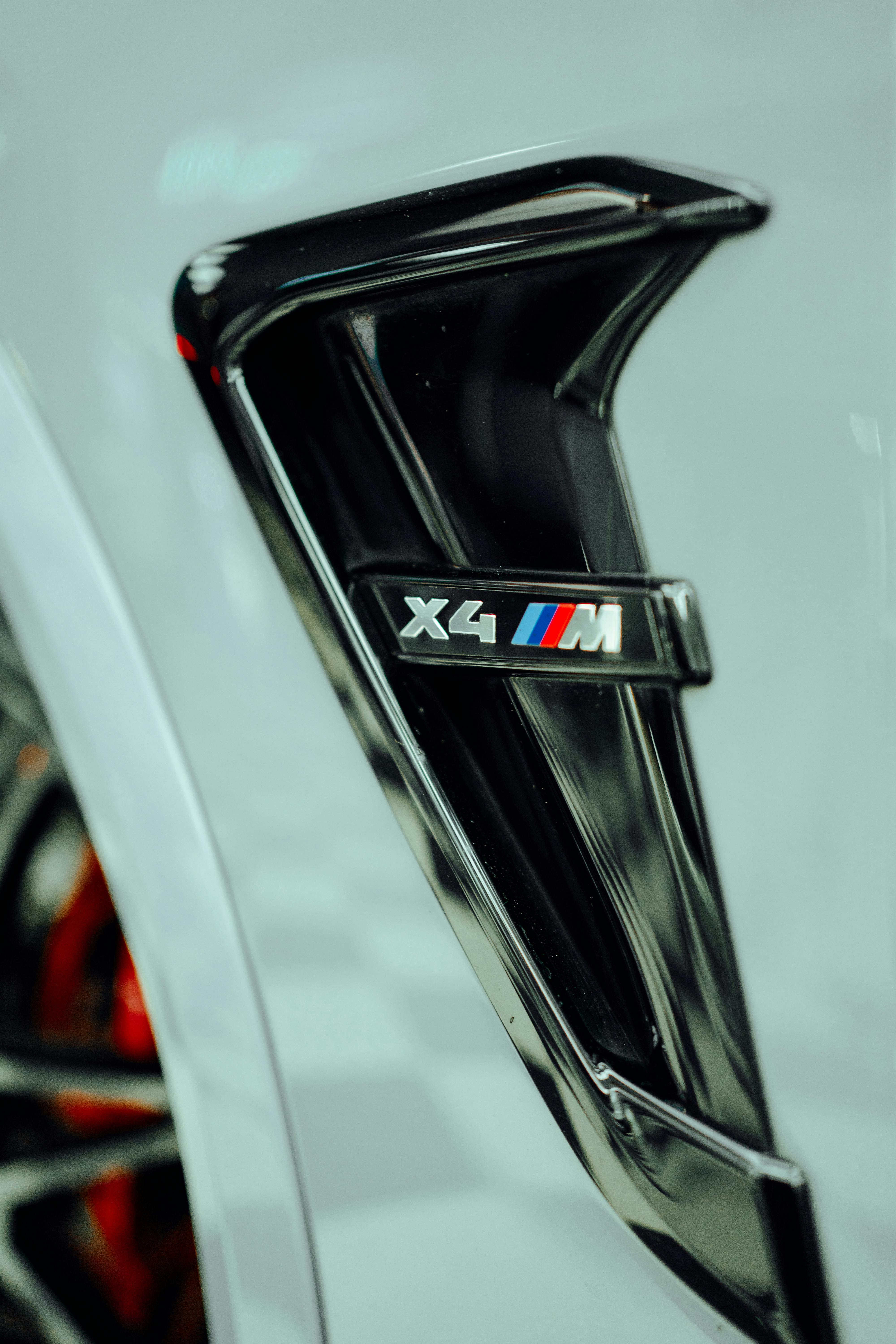 Close-up of an Emblem next to the Wheel of a BMW X4 · Free Stock Photo