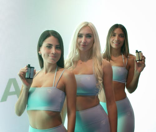 Three Young Women in Sportswear Promoting a Product 