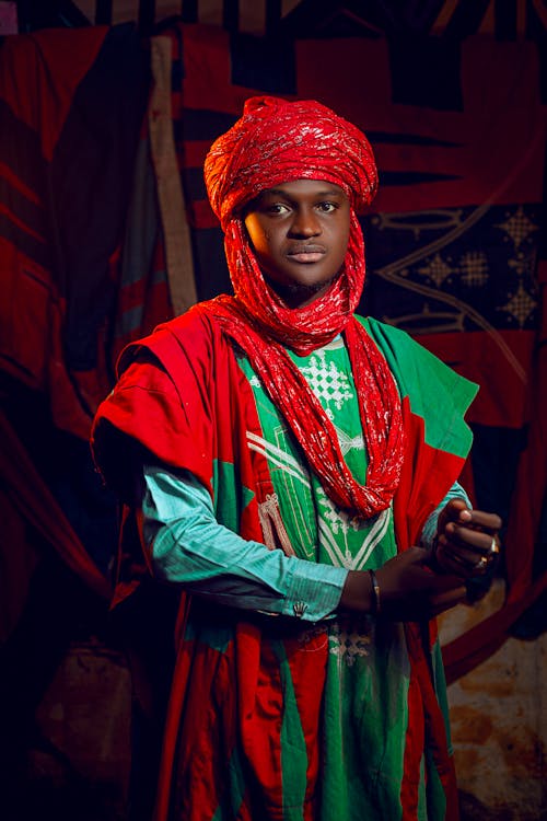 Photo of a Man Wearing Traditional Clothing with a Turban 