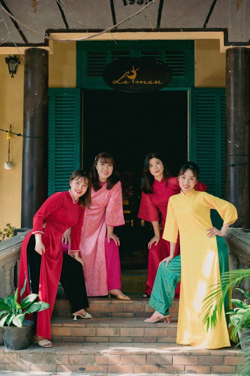 Smiling Women Standing in Traditional Clothing 