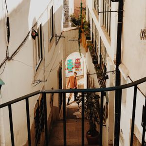 Sunlit stepped alleyway in Lisbon's old town — photo by Mark Neal on Pexels