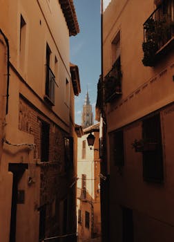 Explore the historic architecture of Toledo with a view of the city's iconic cathedral spire.