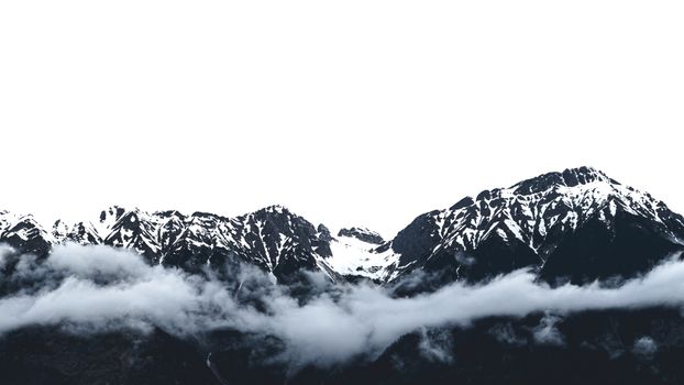 Dramatic snow-capped mountains with clouds in Innsbruck, providing a breathtaking natural landscape.