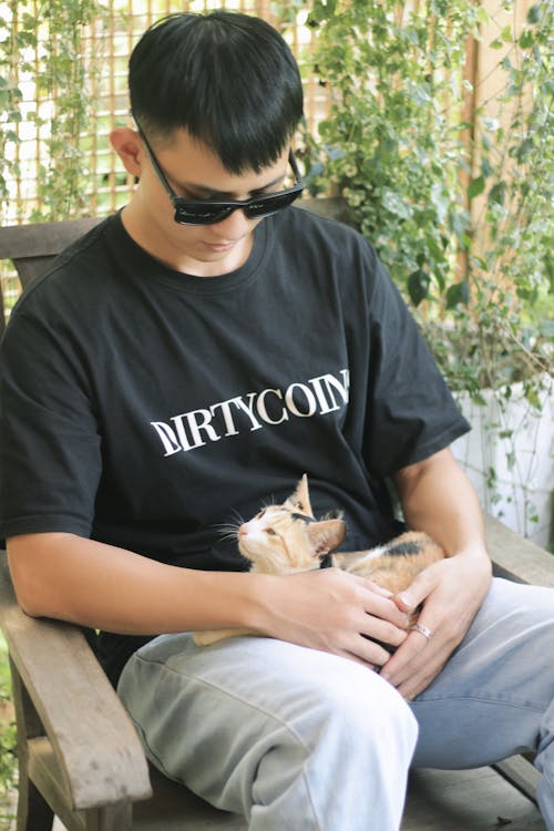 Man in Sunglasses Sitting with Cat