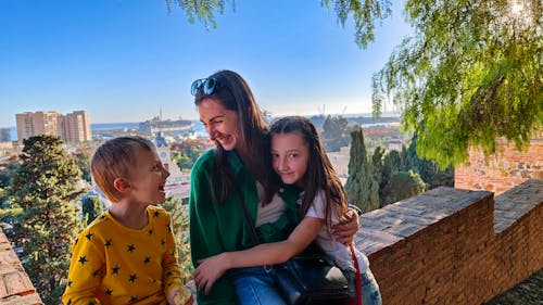 Joyful family sun day travel in Spain. Mother, son, and daughter create fun-filled memories under the sunny skies