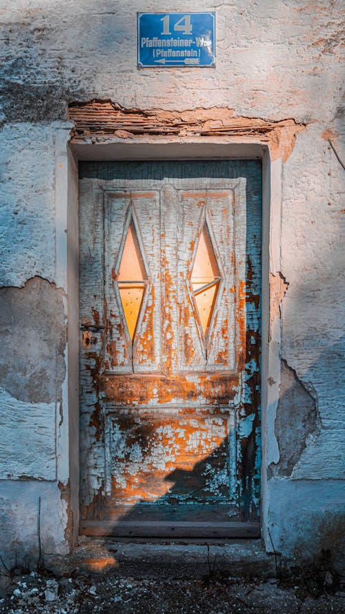 An old door with a blue sign on it