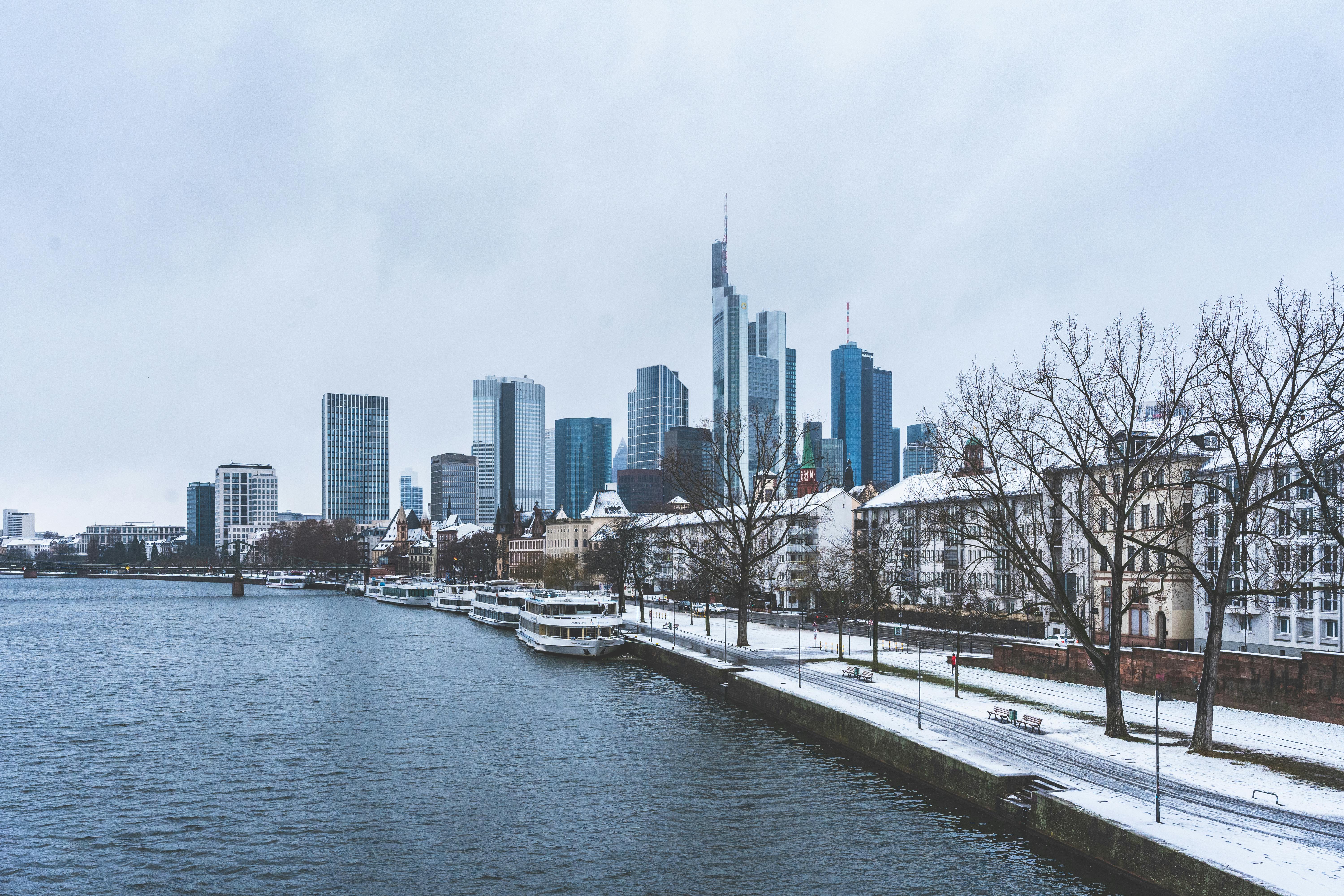 frankfurt skyscrapers behind river in winter