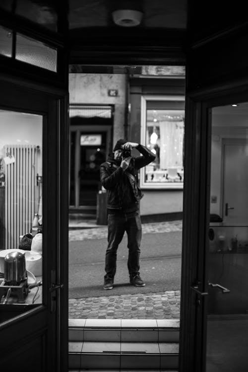 A man taking a photo of himself in a doorway