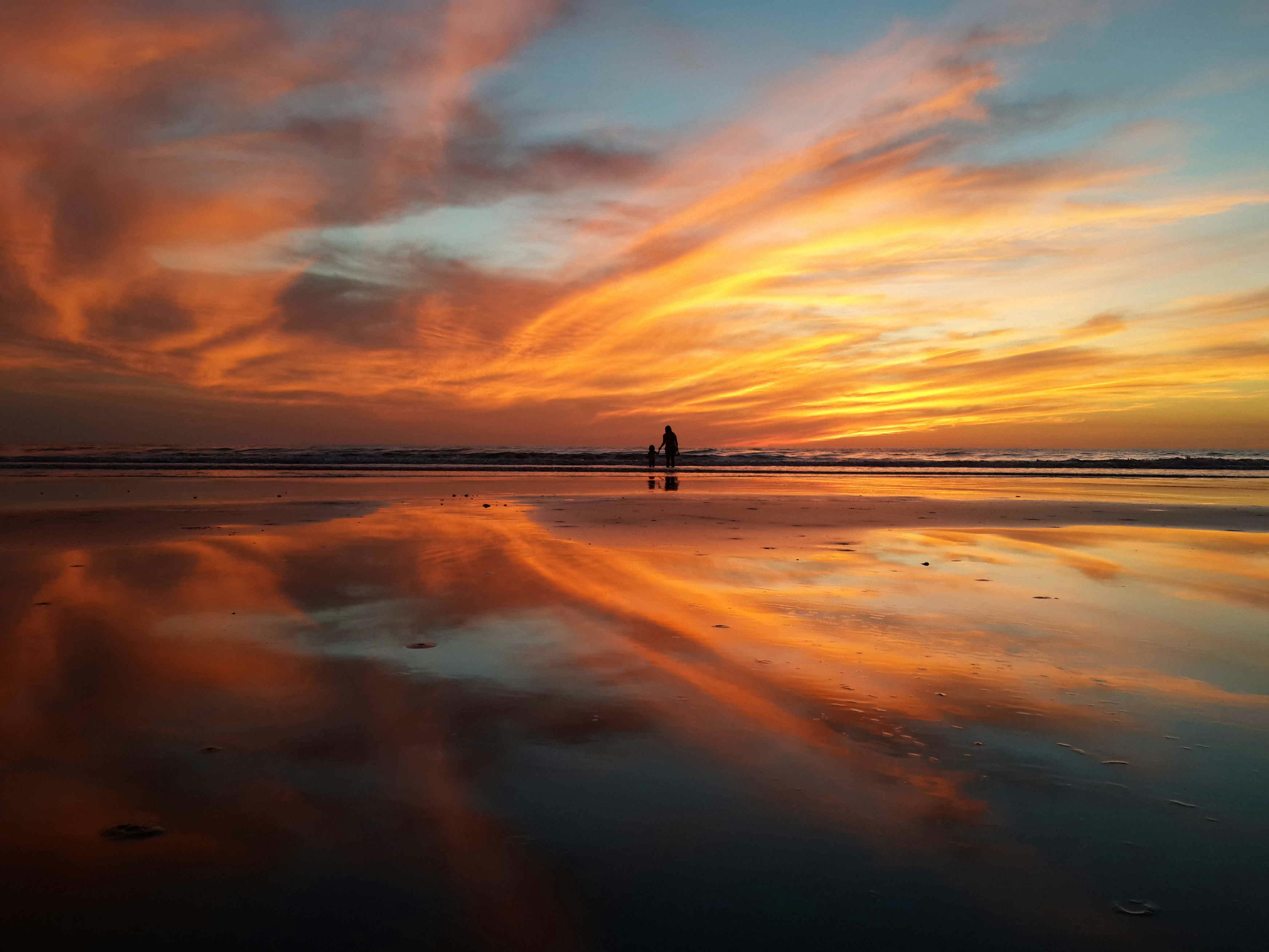 silhouette of people at the beach