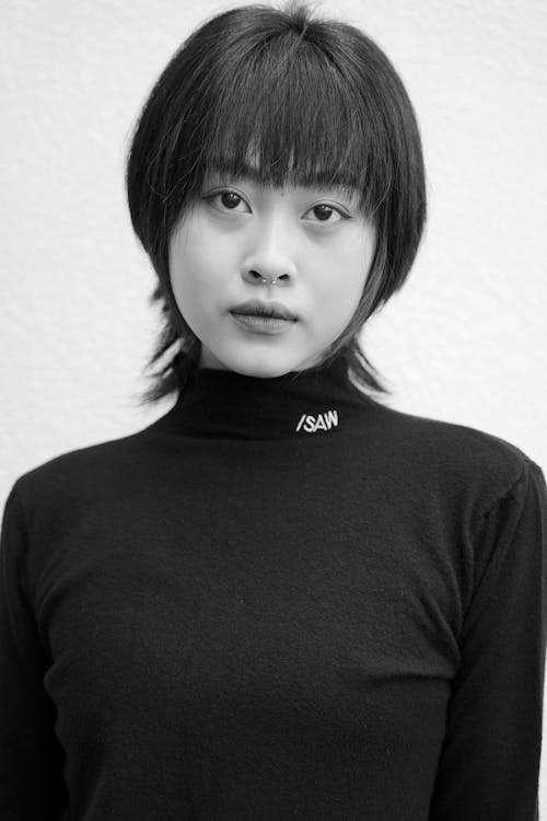 A black and white photo of a woman with short hair