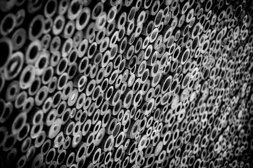 Free Striking black and white photo featuring a surreal arrangement of bamboo circles, forming a unique texture. Stock Photo