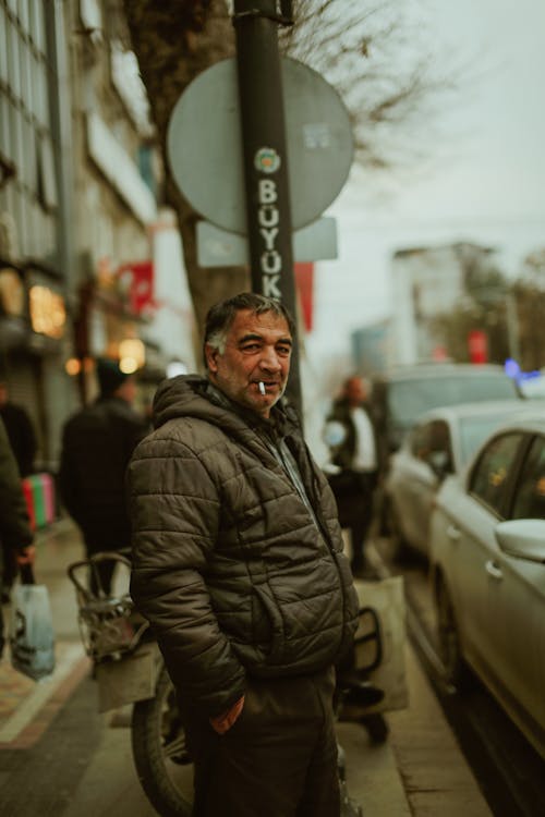 Elderly Man in Jacket Smoking Cigarette