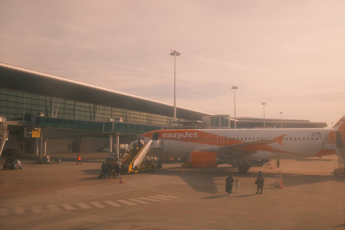 A large orange and white airplane sitting on the tarmac