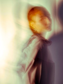 Conceptual blurred portrait of woman in warm and soft tones.