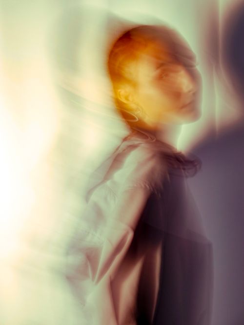 Free Conceptual blurred portrait of woman in warm and soft tones. Stock Photo