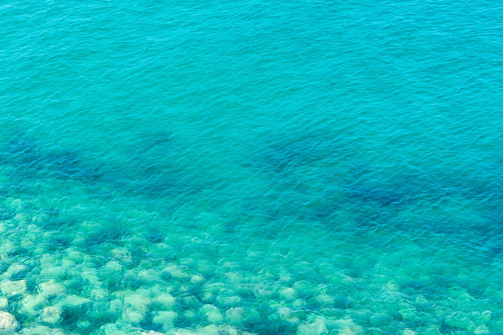 Clear turquoise sea over a shallow stone seabed — photo by Jan van der Wolf on Pexels