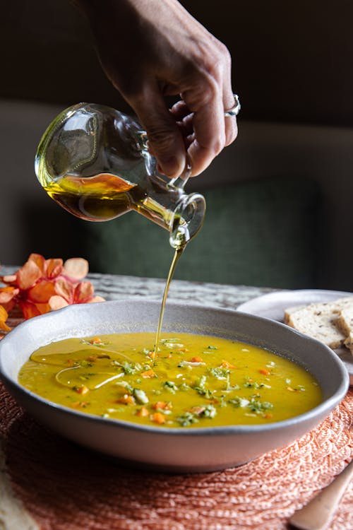 Pouring Olive Oil to Soup