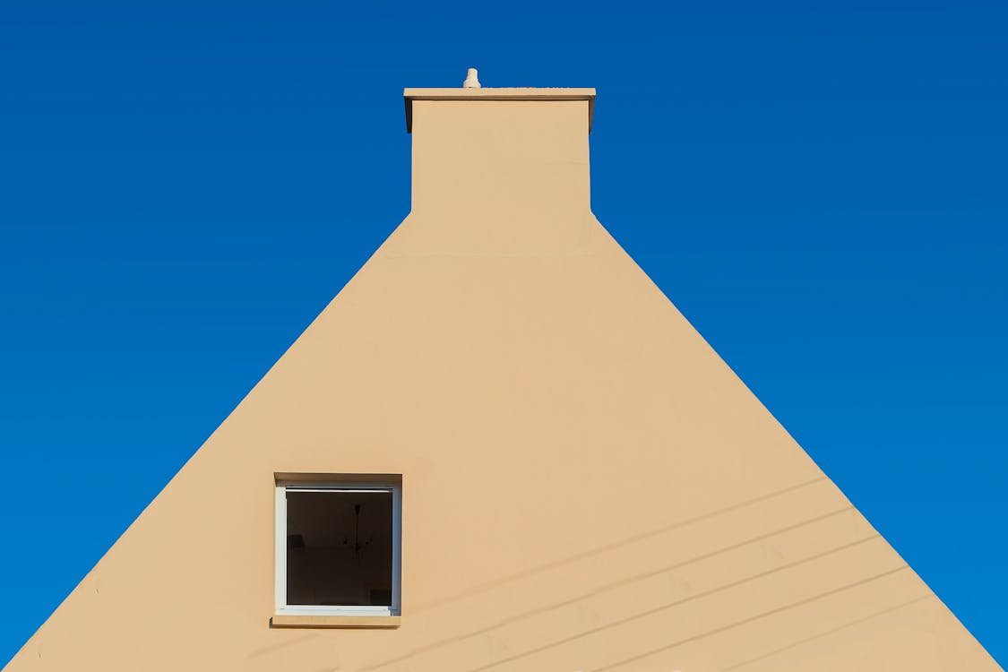 Facade of a House with a Window against Blue Sky 