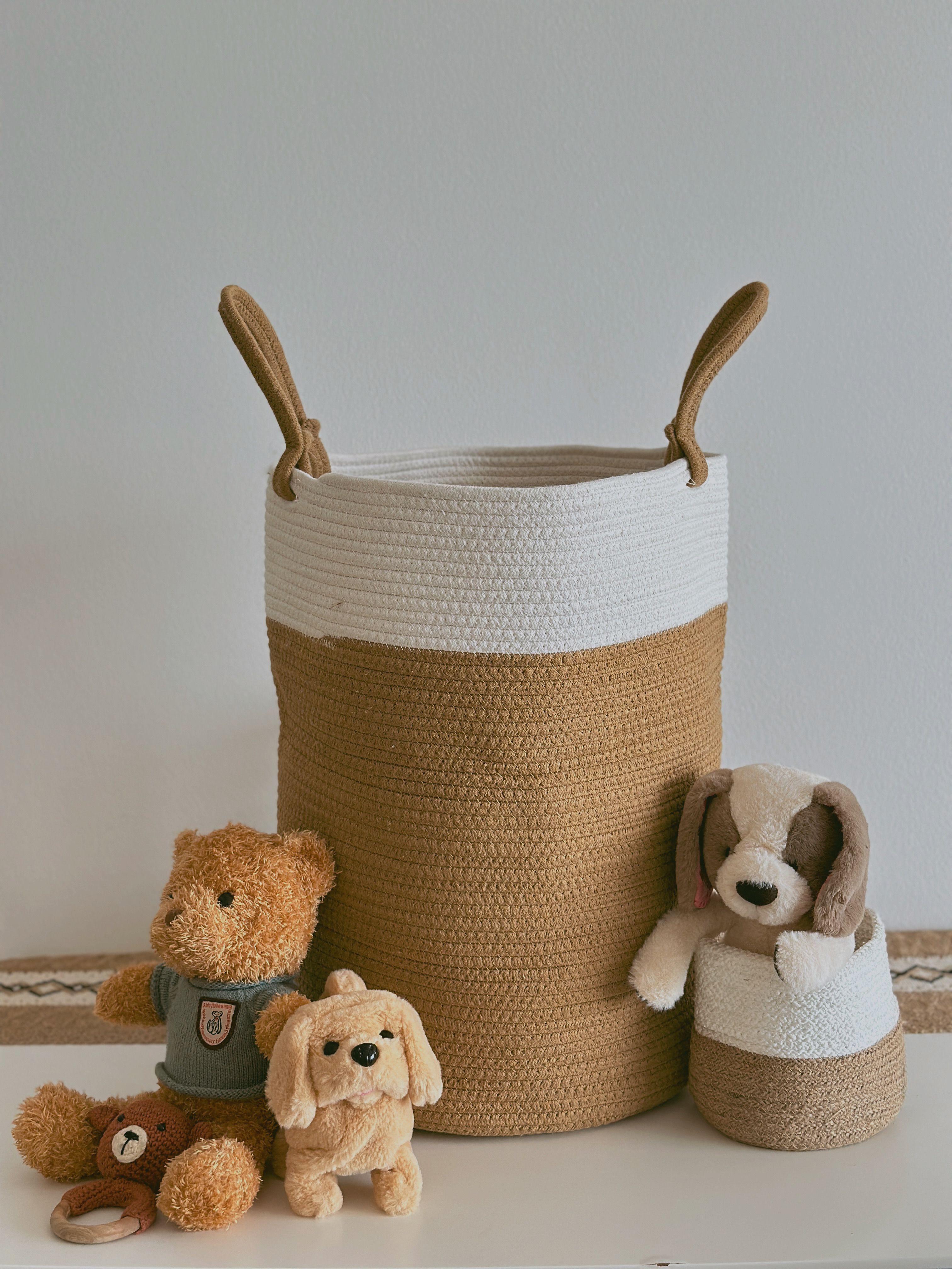 Soft toys and teddy bears stored neatly in a woven basket