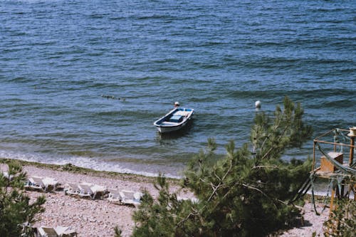 A boat is sitting on the beach near the water
