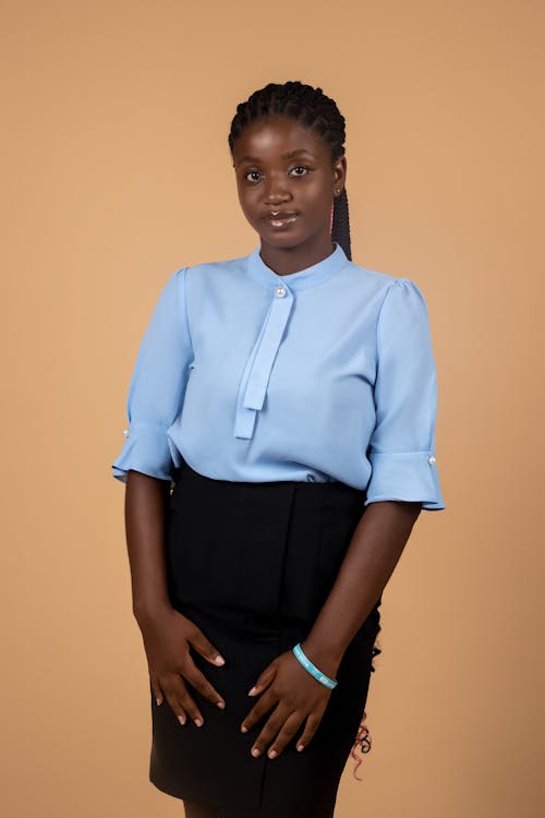 Young Woman in a Blue Blouse and a Black Skirt 