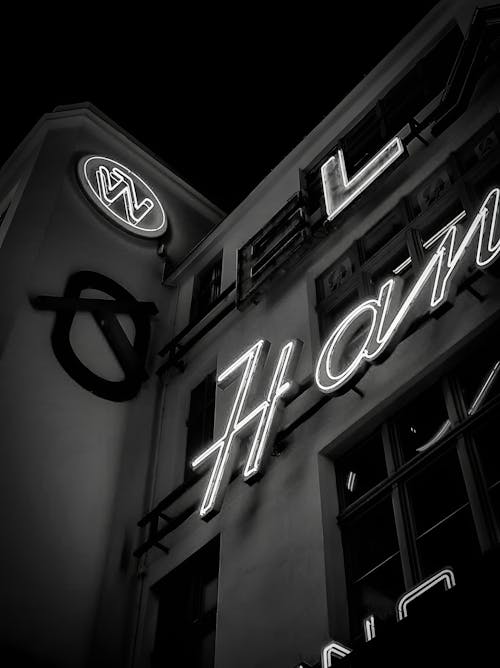 A black and white photo of a neon sign