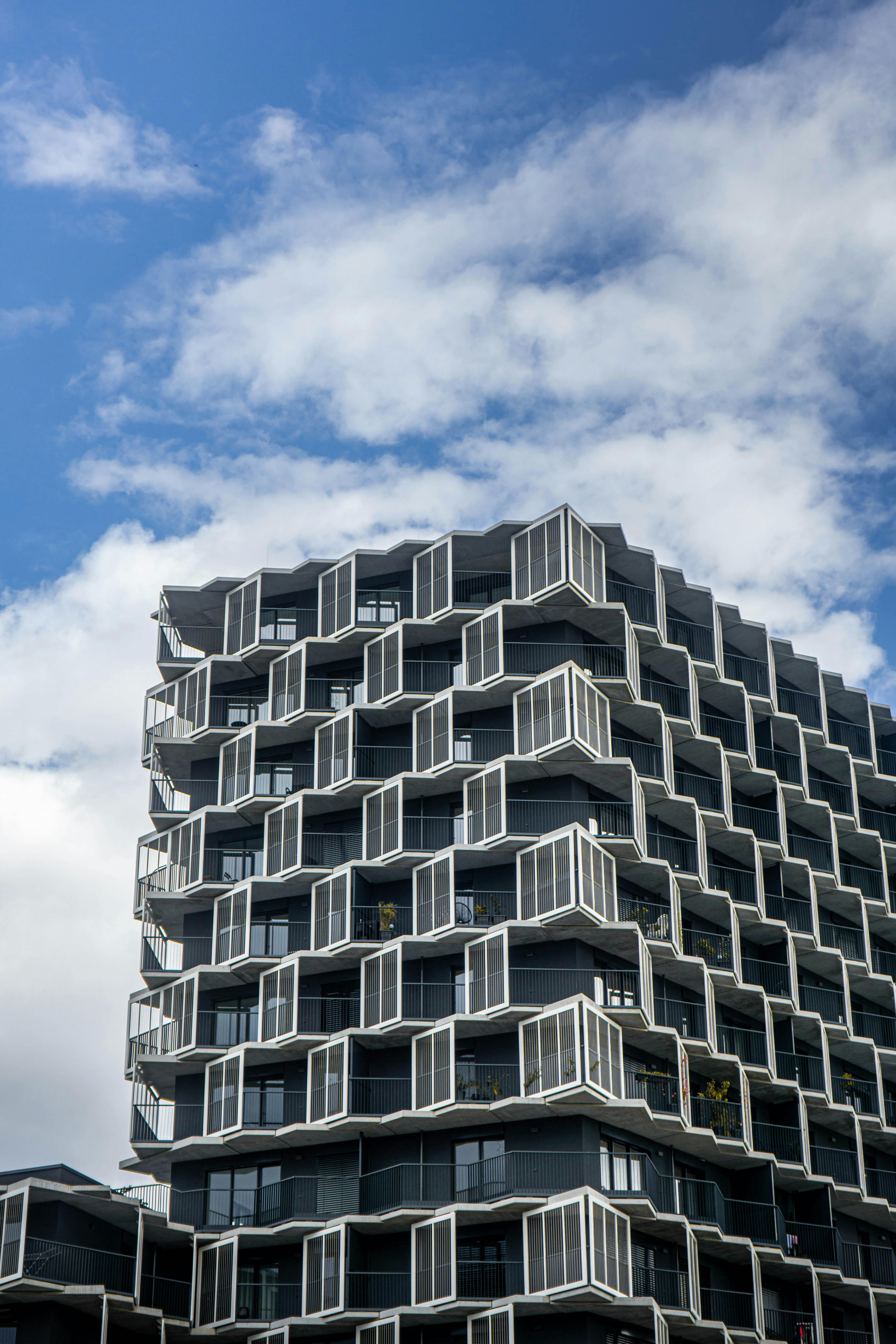 Contemporary high-rise building showcasing geometric design and urban environment.