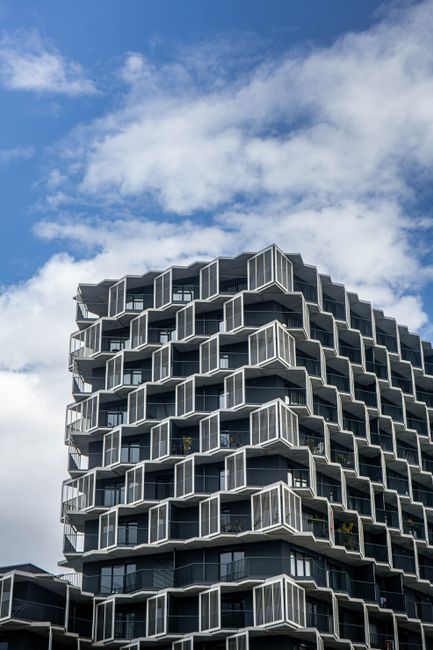 Contemporary high-rise building showcasing geometric design and urban environment.