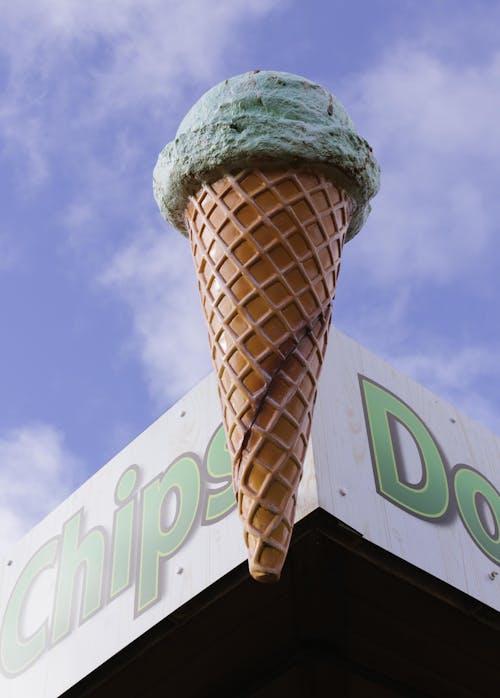 A sign for chips and doughnuts with an ice cream cone on top