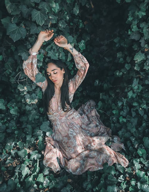 Free Young Woman Lying on the Ground among the Leaves  Stock Photo