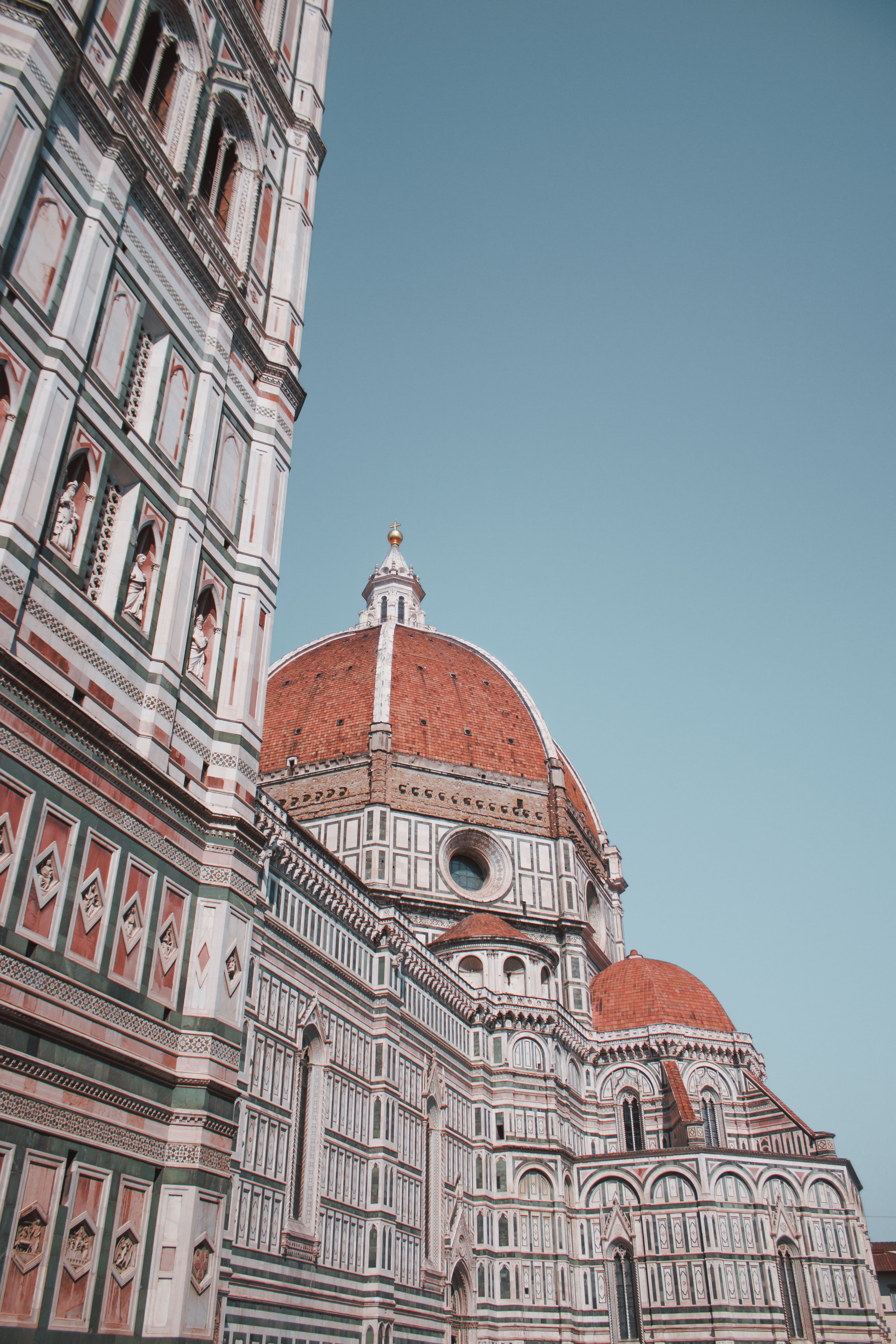 Stunning view of Florence Cathedral's iconic dome, showcasing Renaissance architecture against a clear sky.