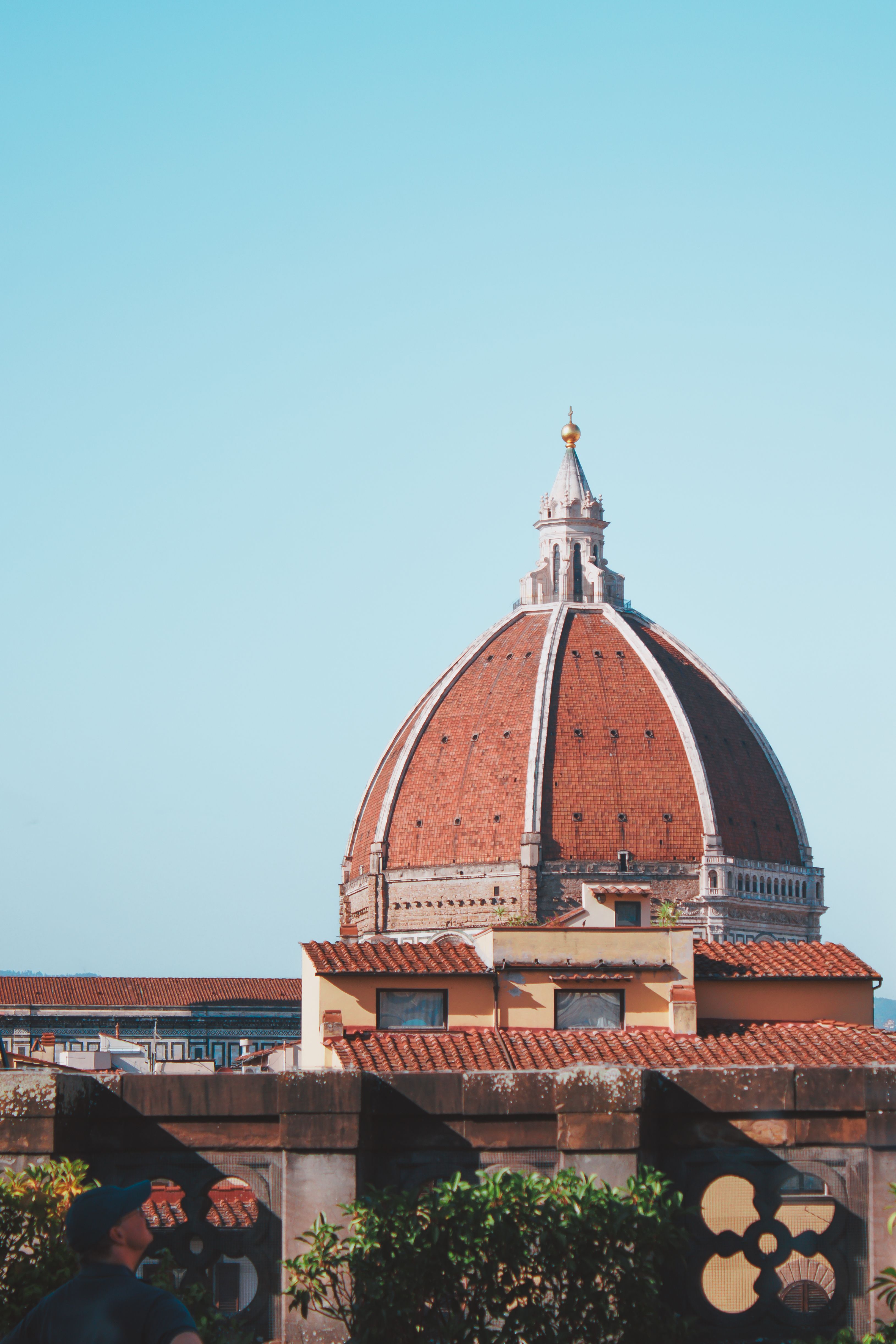Iconic view of Florence Cathedral's dome under a clear blue sky, capturing Renaissance architecture.