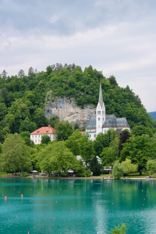 Free Serene landscape capturing the Church of St. Martina by the turquoise waters of Lake Bled, Slovenia. Stock Photo