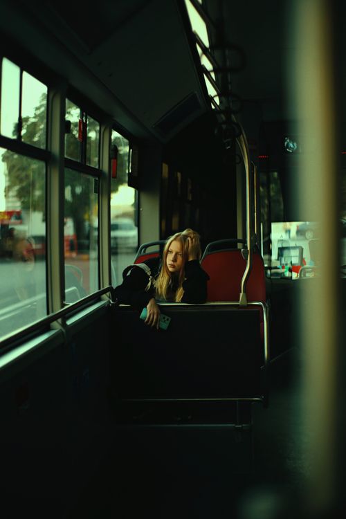 Free Blonde woman deep in thought sitting on a city bus. Stock Photo