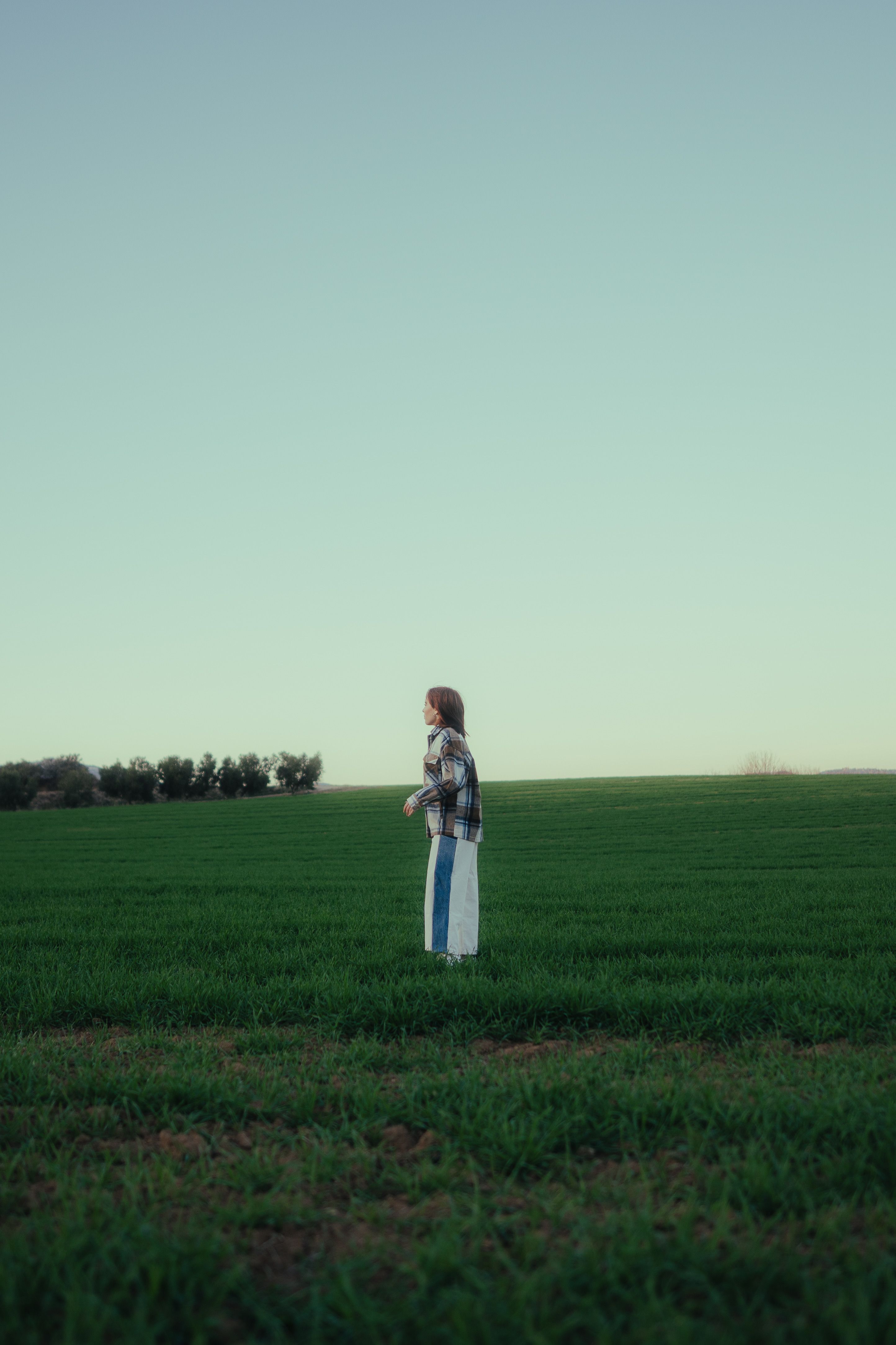 Woman Standing on Grassland under Clear Sky · Free Stock Photo