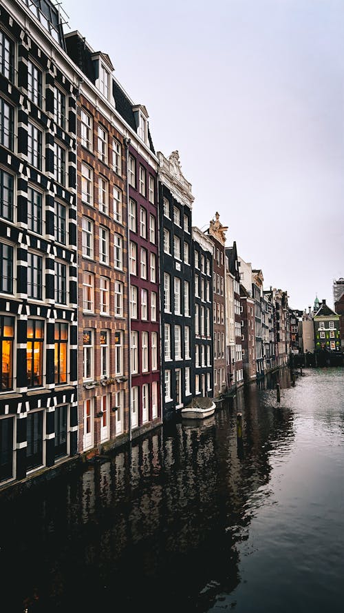 A canal in amsterdam with buildings on both sides