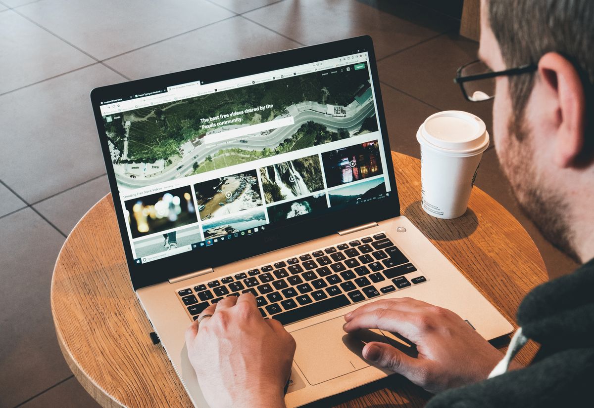 Founder working thoughtfully at a laptop in a modern workspace
