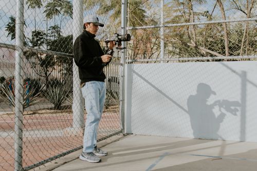 Free Photographer capturing urban scenes with camera in daylight. Stock Photo