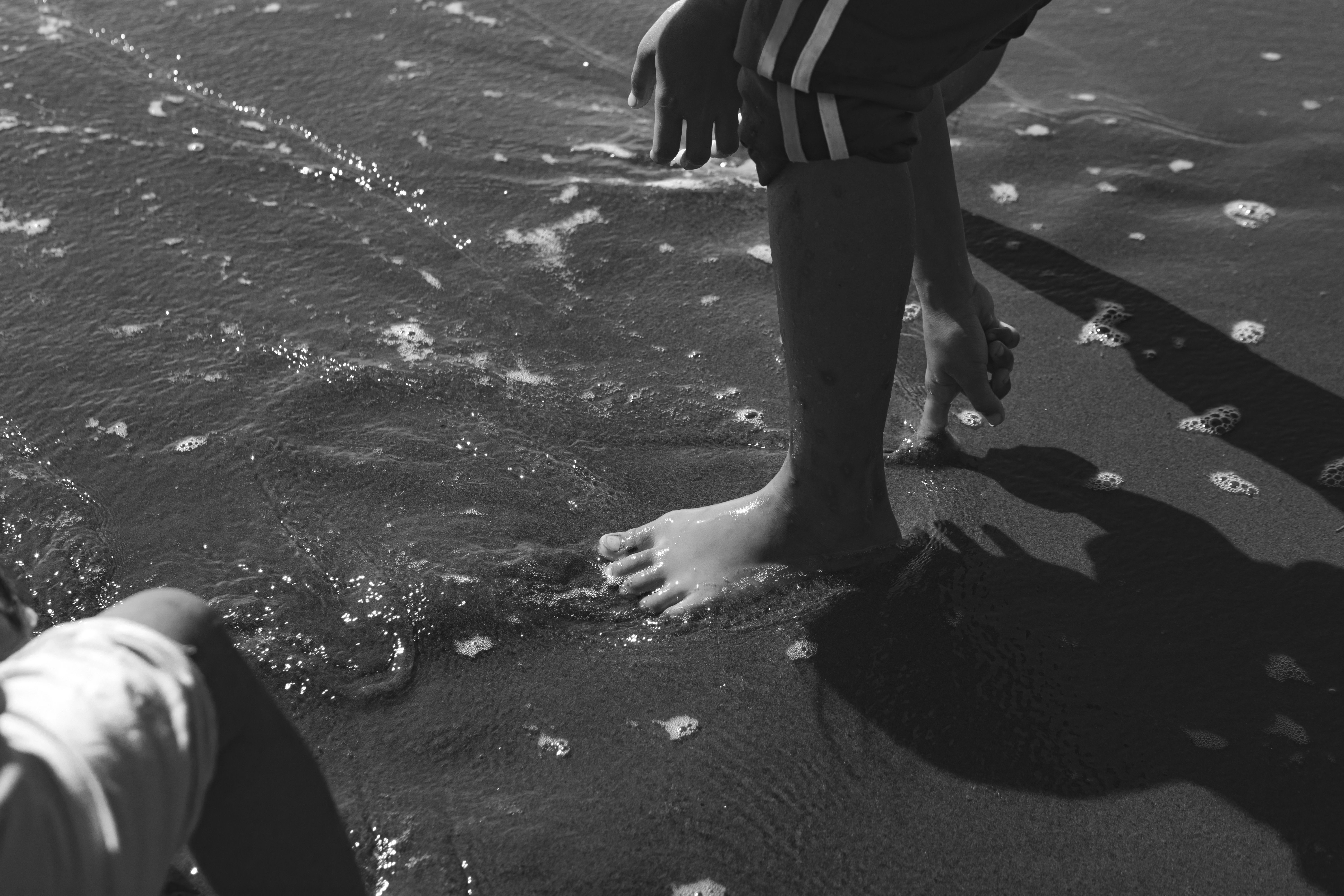 Sea Water Flooding the Beach at the Childrens Feet · Free Stock Photo